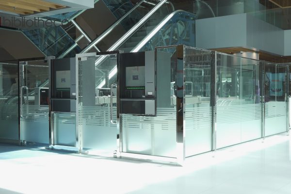 The image shows two machines to self checkout items.