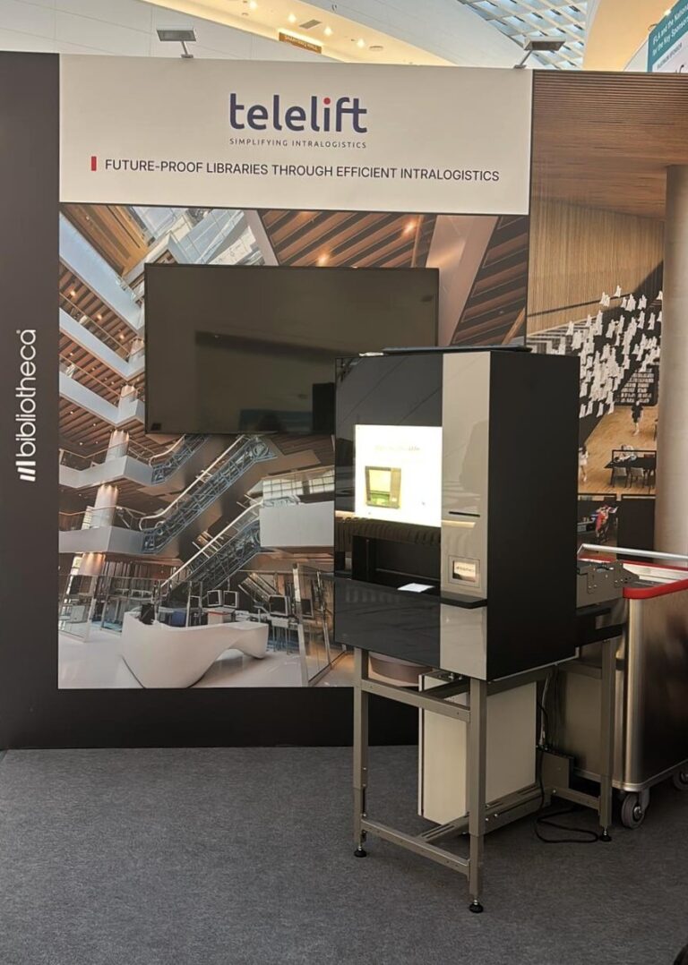The Bibliotheca flexAMH automated materials handling system at the IFLA 2025 booth, simplifying library logistics.