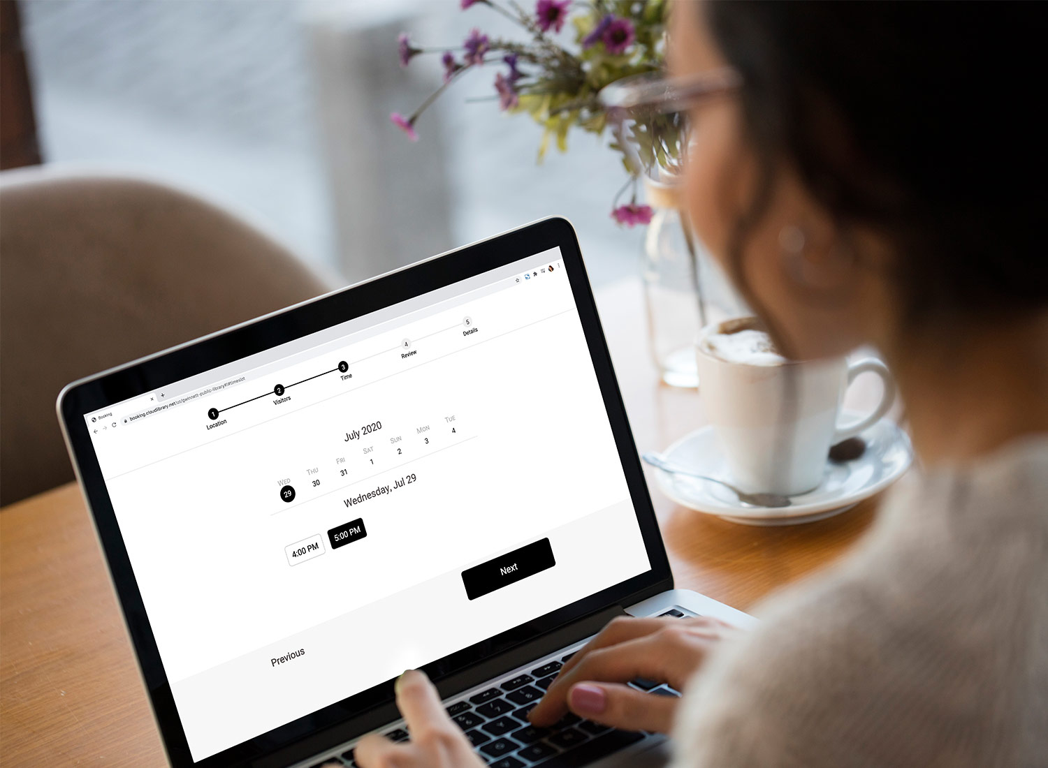 Lady making library reservation on her laptop