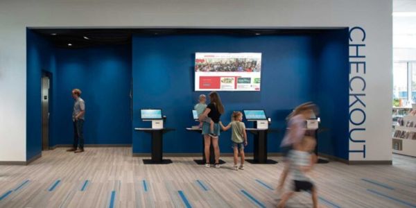 Patrons using selfCheck™ kiosks at Spanish Fork Public Library, US, where 76% of transactions are now self-service.